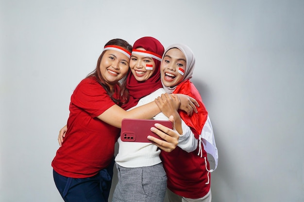 group of people using the red and white attributes to commemorate Indonesia independence day