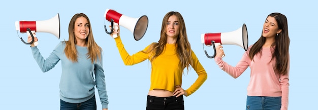 Group of people with colorful clothes taking a megaphone that makes a lot of noise 