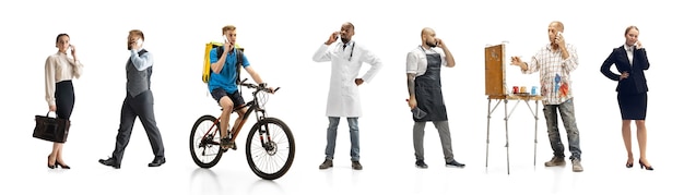 Group of people with different professions on white studio wall