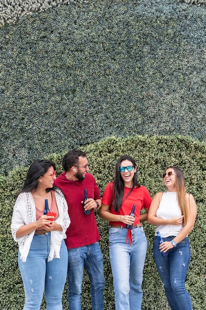 Group of people with soda bottles talking in the open air