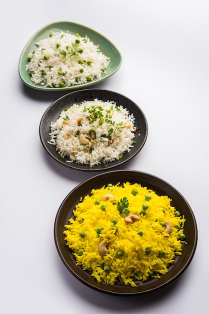 Group photo of indian rice with green peas and garlic served with jeera dal fry, selective focus