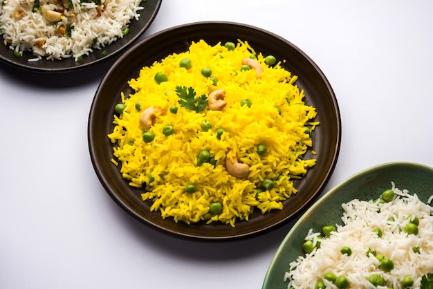 Group photo of indian rice with green peas and garlic served with jeera dal fry, selective focus