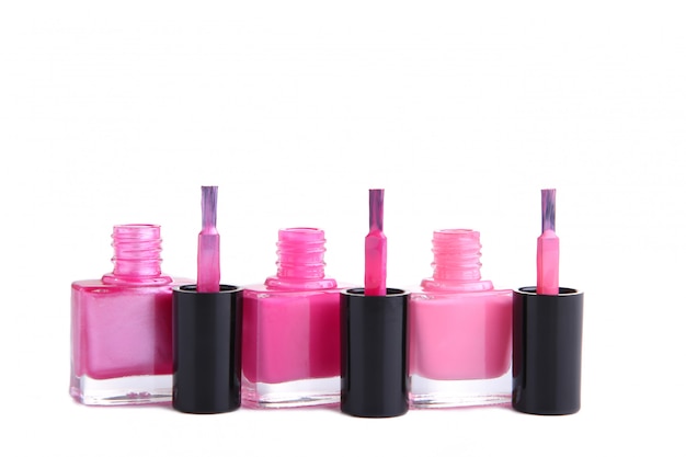 Group of pink nail polishes isolated on white