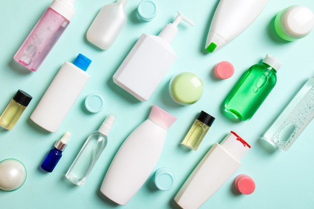 Group of plastic bodycare bottle Flat lay composition with cosmetic products on colored surface