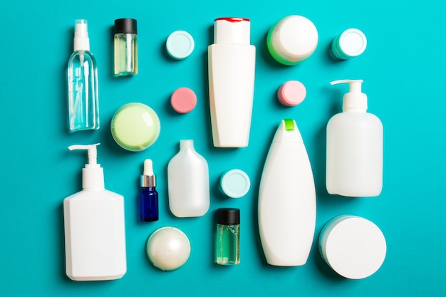 Group of plastic bodycare bottle Flat lay composition with cosmetic products on colored surface