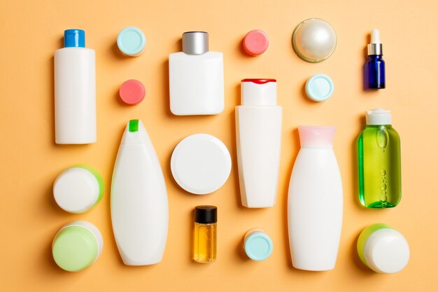 Group of plastic bodycare bottle Flat lay composition with cosmetic products on colored surface