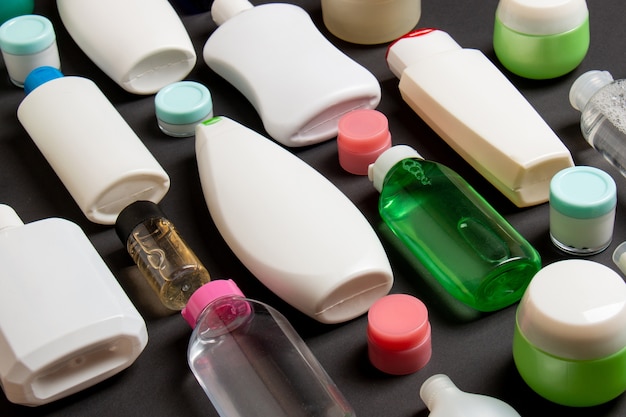 Группа пластиковых бутылок для ухода за телом Плоская композиция с косметическими продуктами