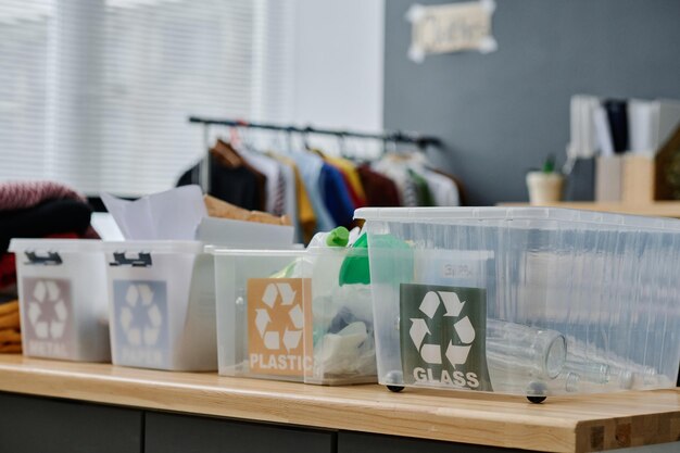 Group of plastic containers for separate litter standing on desk