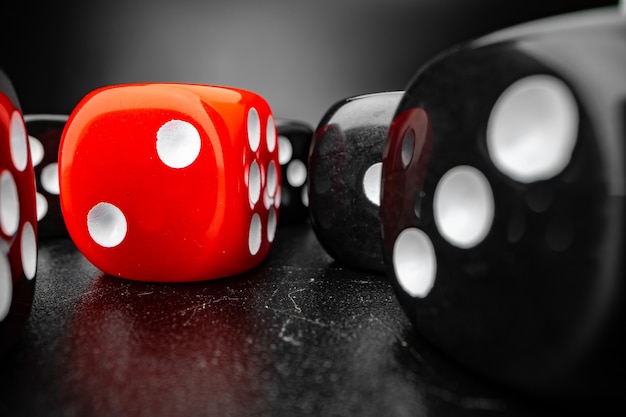 Group of playing dice cubes on black surface macro