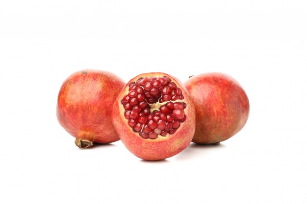Group of pomegranate isolated on white. Juicy fruit