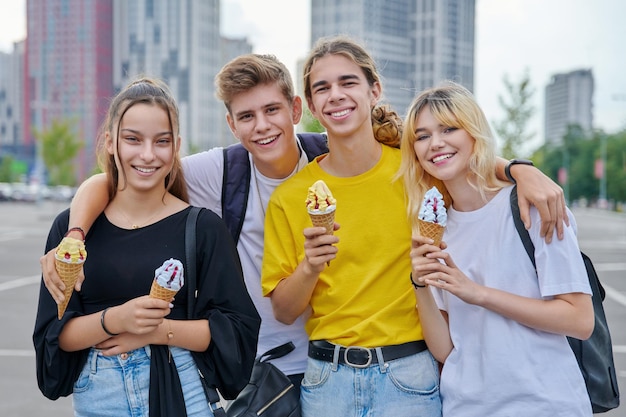 Group portrait of happy teenagers having fun with ice cream