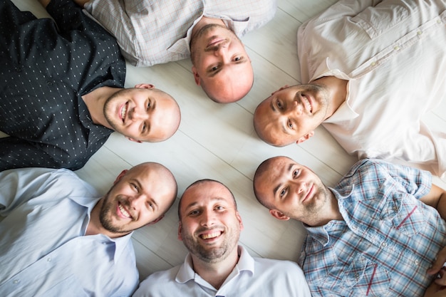 Group portrait of young bald men