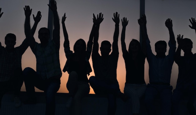 Photo group of positive young people sitting on a windowsill photo with text space