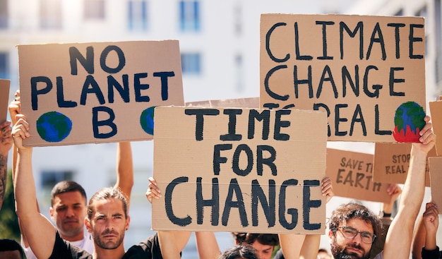 Group poster and together in street for planet climate change and sustainable future in city People cardboard sign and activism for change sustainability or justice for environment in metro road