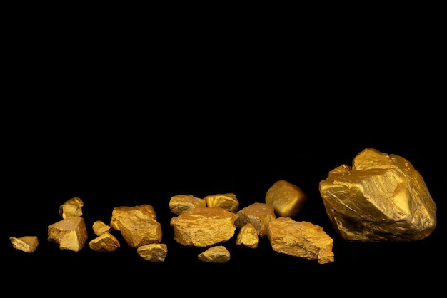 Group of precious gold nugget at black background