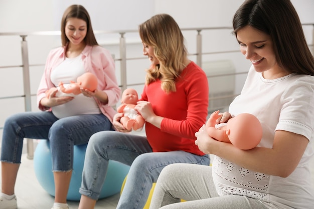 Group of pregnant women at courses for expectant mothers indoors