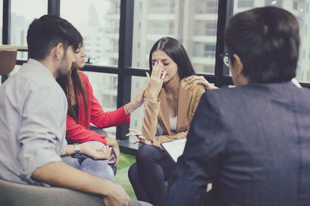 Group problematic young people talking with a guidance counselor.