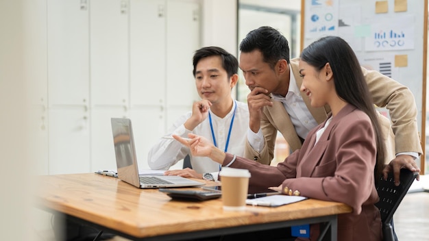 A group of professional Asian businesspeople are focusing on a project brainstorming