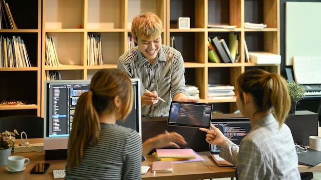 Group of programmers or software developers brainstorming and working on a new project together at the office