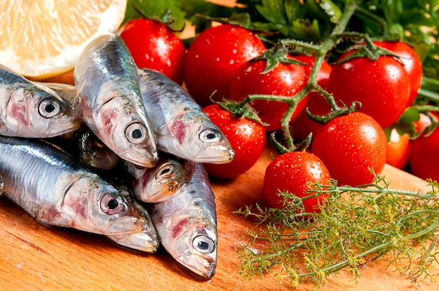 Group of raw sardines on a cutting board