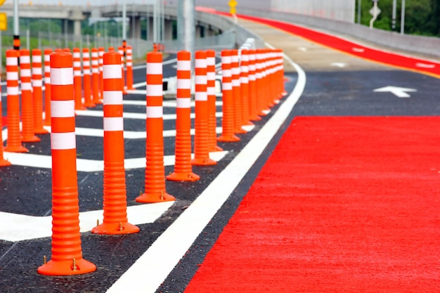 Group of red traffic cones installed on new road  warning sign for safety drive