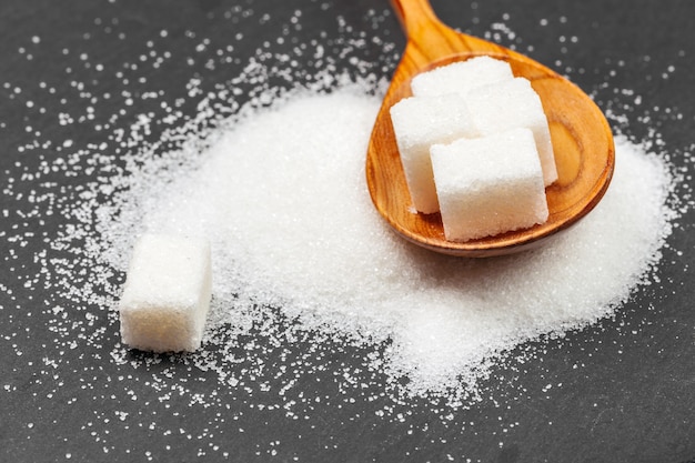 Group of refined white sugar cubes close up