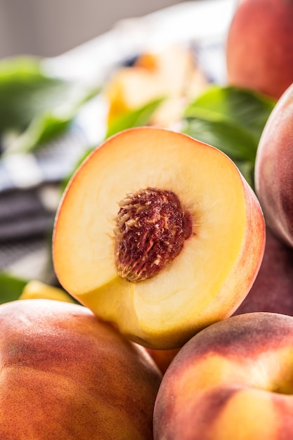 A group a ripe peaches on wooden table.