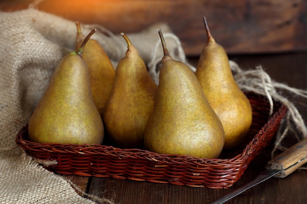 Group of ripe pears lie on old planed wooden boards