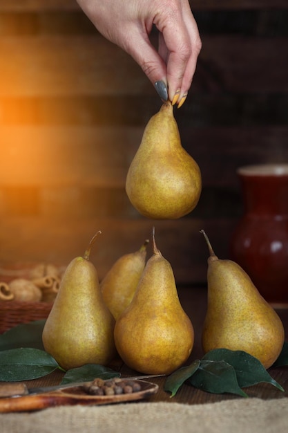 Group of ripe pears lie on old planed wooden boards