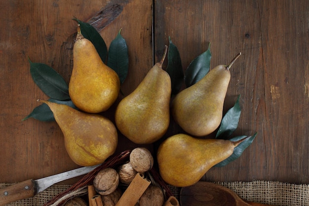 Group of ripe pears lie on old planed wooden boards