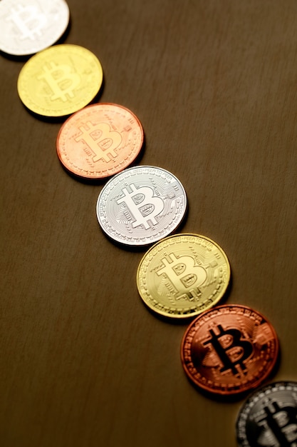 Group row of different cryptocurrency coin on wood background. Idea for new type of money in the economy of the business world.