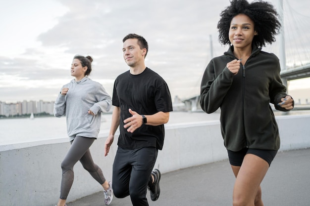 A group of runners of people doing a running fitness workout together Use a fitness watch