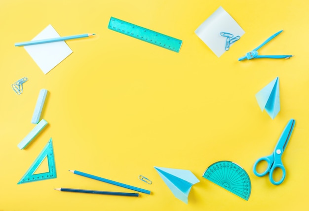 Group of school supplies on yellow