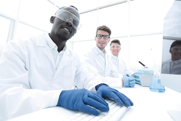 Group of scientists sitting at the laboratory tablescience and technology