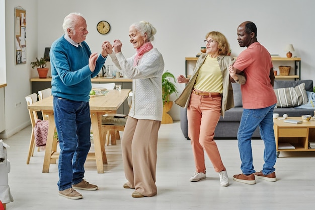 Photo group of senior people dancing together during party in nursing home