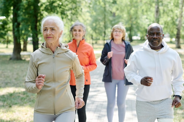 Photo group of senior people doing sport together outdoors