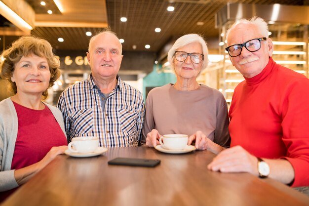 Group of seniors resting in coffee shop