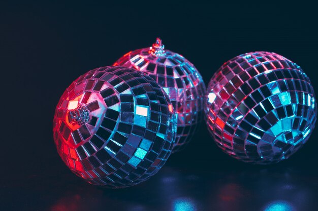 Group of shiny Disco Balls on dark background close up
