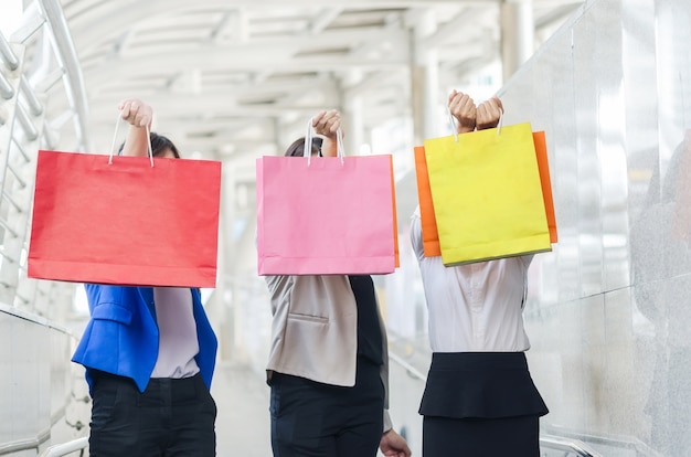 Group of shopping asia women holding up shopping bags