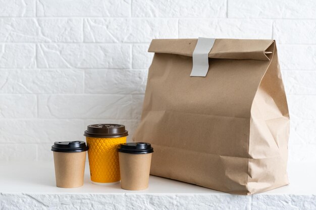 Photo group shot of biodegradable and recyclable food packaging on white background, paper plates, cups, containers, bags, no logos.