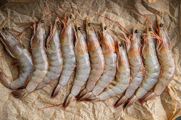 A group of shrimp on a brown paper.