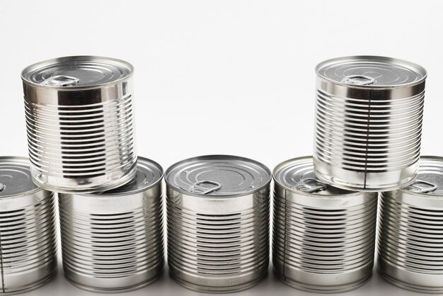 Group of silver canned food on white background.