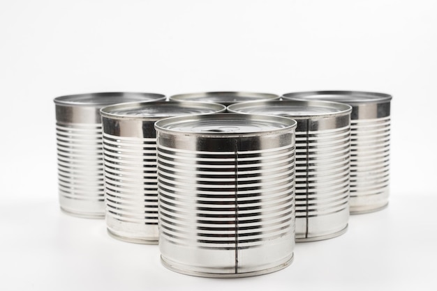 Group of silver canned food on white background.