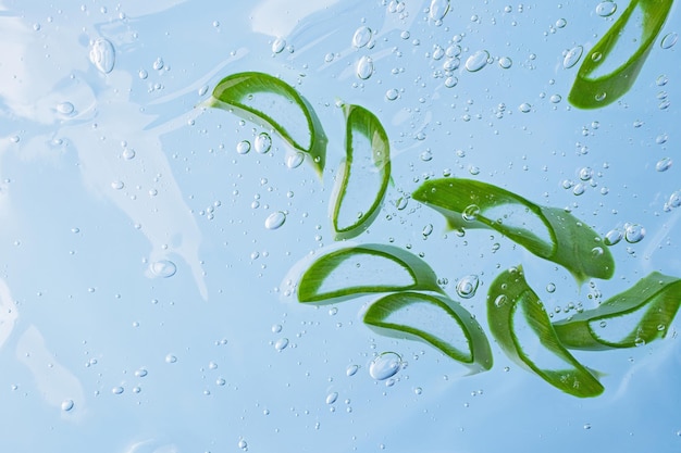 Group of slices of aloe vera in the cosmetics gel with bubbles insideCosmetics background