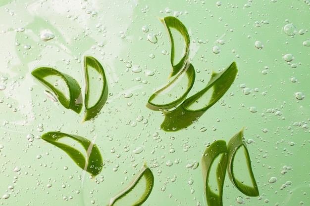 Group of slices of aloe vera in the cosmetics gel with bubbles insideCosmetics background