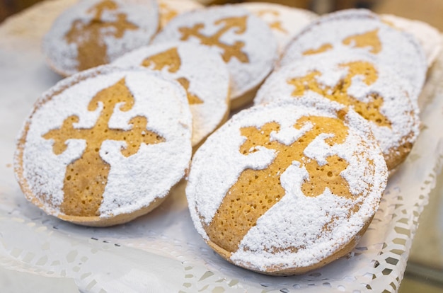 Group of small Tarta de Santiago on bakery store window of Santiago de Compostela