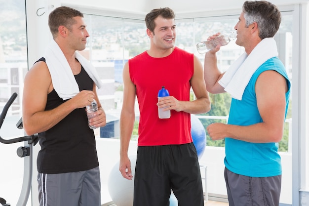 Group of smiling men talking each other 