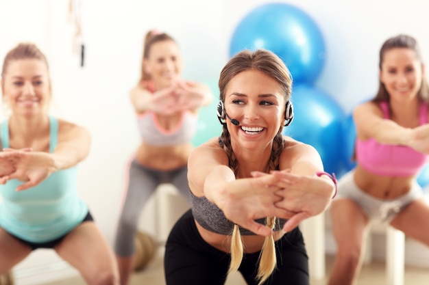 Group of smiling people doing aerobics