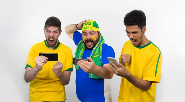 Group of soccer fans  looking cell phone isolated on white background