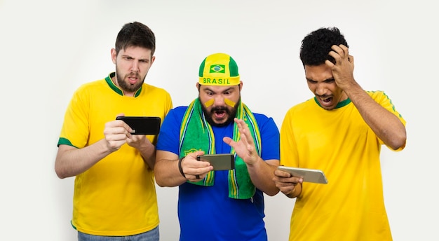 Group of soccer fans  looking cell phone isolated on white background